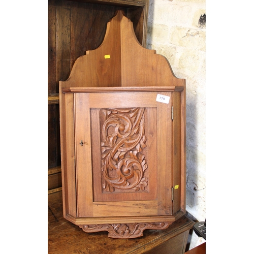 779 - Carved oak corner cabinet.