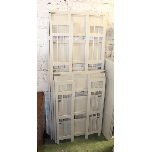 786 - Pair of painted folding shelf units.