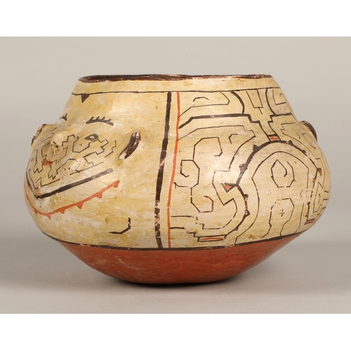 18 - Shipibo terracotta pottery bowl, 20th C, squat form, two faces with protruding features on opposite ... 