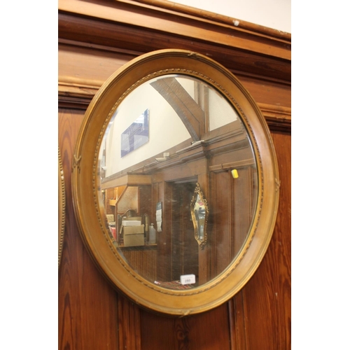 280 - Oval gilt framed wall mirror, H73cm.