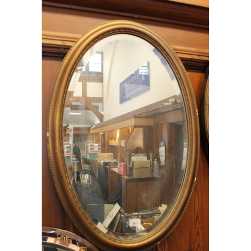 281 - Oval gilt framed wall mirror, H84cm.