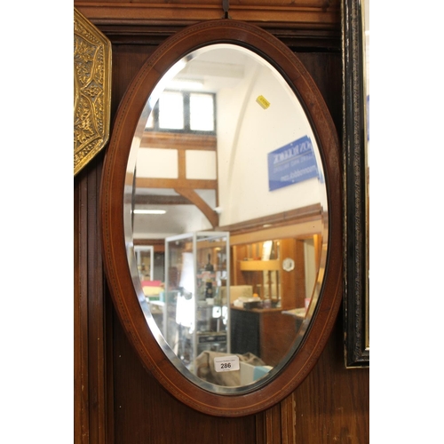 286 - Oval wooden frame wall mirror, H64cm.