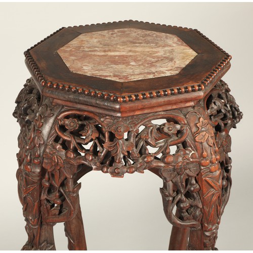 530 - Chinese hardwood jardiniere stand with octagonal top with rouge marble inset, with ornately carved a... 