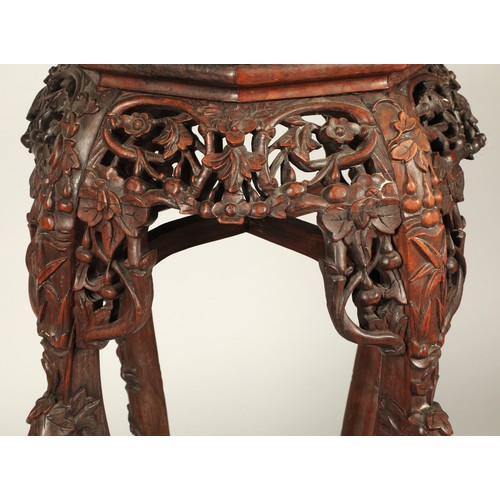 530 - Chinese hardwood jardiniere stand with octagonal top with rouge marble inset, with ornately carved a... 