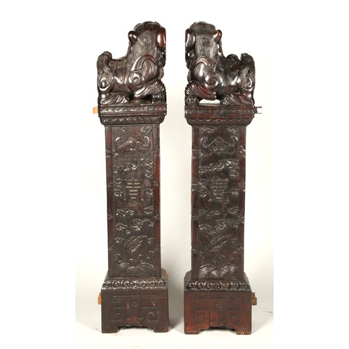 538 - Pair of carved hardwood Chinese foo dogs.128cm high