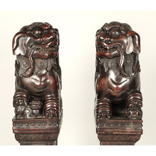 538 - Pair of carved hardwood Chinese foo dogs.128cm high