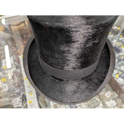 53 - Top hat in original leather hat box and a bowler hat.