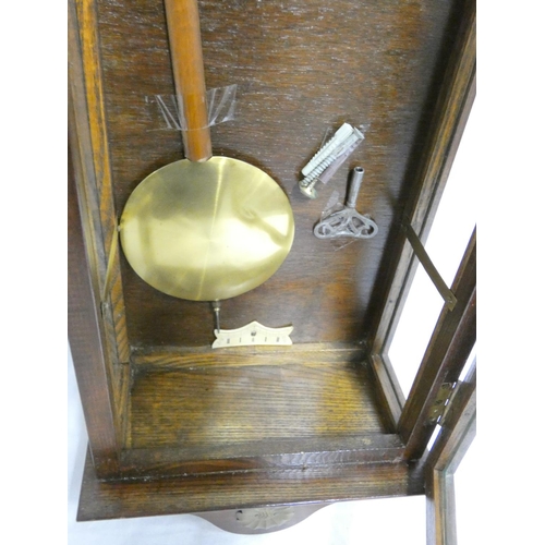 139 - Early 20th century oak cased wall clock with ivorine and gilt dial. Height 99cm. 