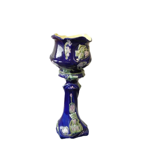 400 - Art Nouveau majolica pottery jardiniere and stand finished in a blue slip glaze and decorated with b... 