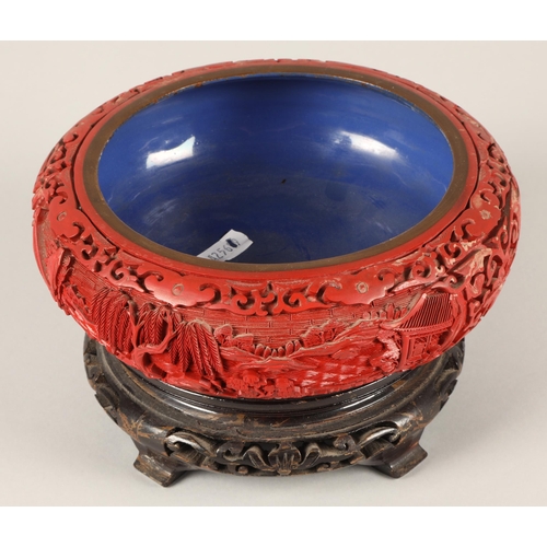 20 - Carved red cinnabar lacquer brass bowl with blue interior, 13.5cm opening diameter, on wooden stand ... 