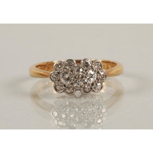 56 - 18ct gold and platinum ring set with diamonds in a double daisy cluster design, ring size M, 3g