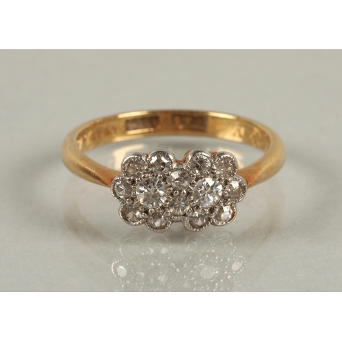 56 - 18ct gold and platinum ring set with diamonds in a double daisy cluster design, ring size M, 3g