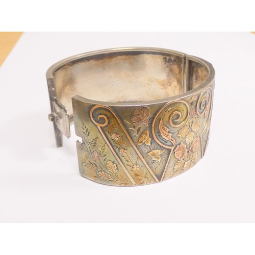 69 - Victorian silver bangle with tri colour gold wire floral inlay panels, and another. 53g.