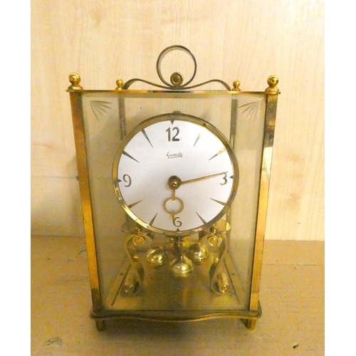 87 - Brass Lunde anniversary clock, four glass panels.