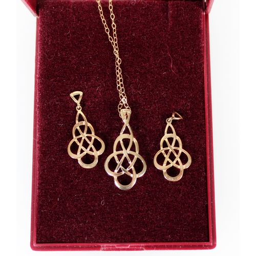 424 - Yellow metal knotwork pendant and matching pair of earrings.