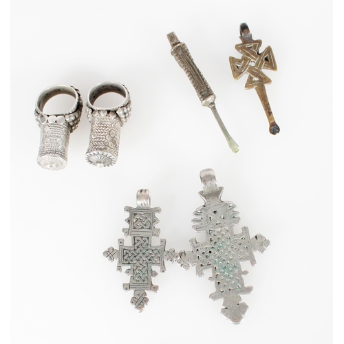 442 - Two Yemen silver tower rings, two North African coptic cross pendants and two pendants with small sp... 