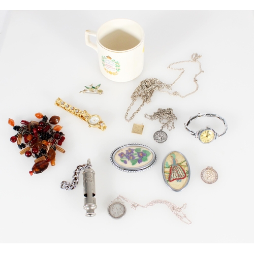 447 - Costume jewellery to include an amber necklace, brooches, an Acme whistle etc., and a commemorative ... 