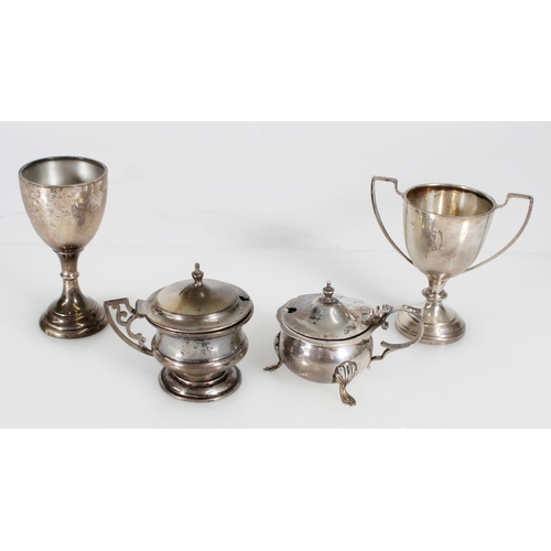 489 - Two hallmarked silver condiment pots, egg cup and a small silver trophy, without liners 183g.