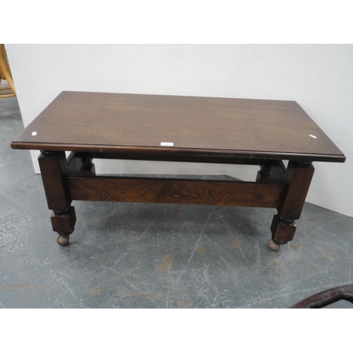 443 - Oak coffee table on castors and an oval wall mirror.  (2)