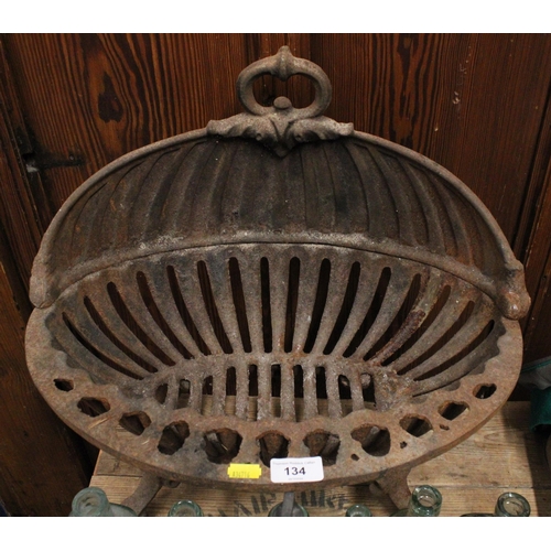 134 - Wrought iron fire basket in the form of a shell.