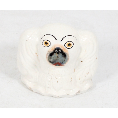 205 - Staffordshire spaniel head money bank.