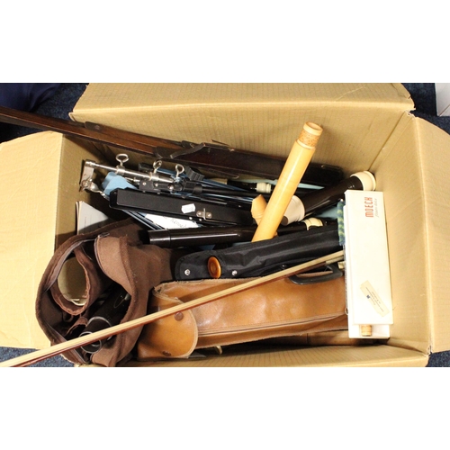 259 - Box containing musical instruments to include a chanter, a clarinet, etc., and a violin bow.