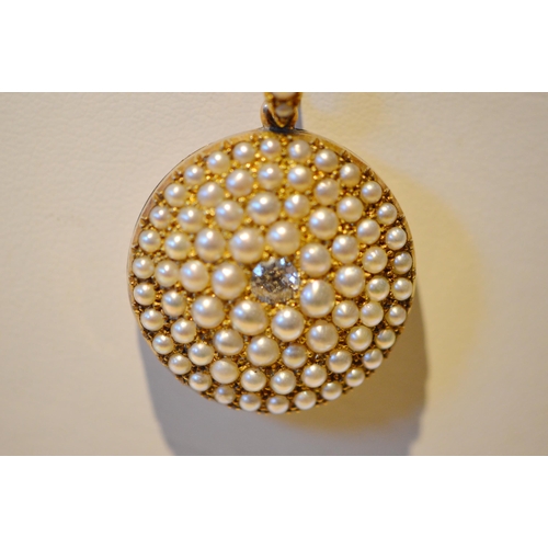 171 - Edwardian gold circular locket with diamond brilliant measuring .25ct and pavé pearls of typical qua... 