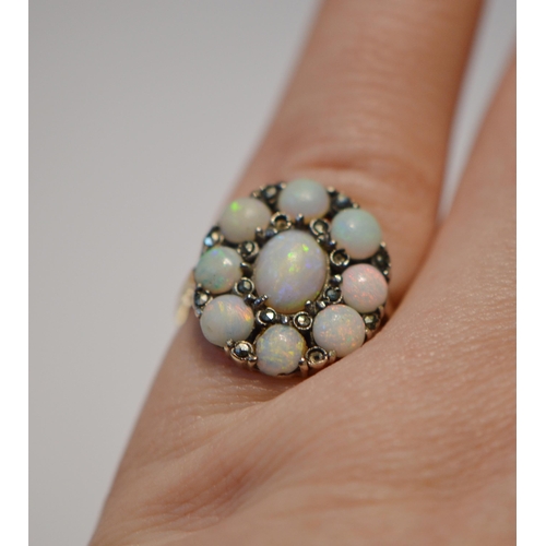 175 - Opal and marcasite oval cluster ring in silver, size L.