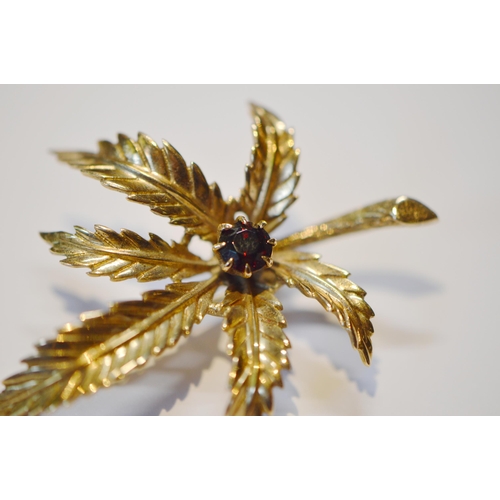 200 - 9ct gold and garnet lady's leaf brooch set with a garnet to the centre, 5cm long, 7.3g gross.