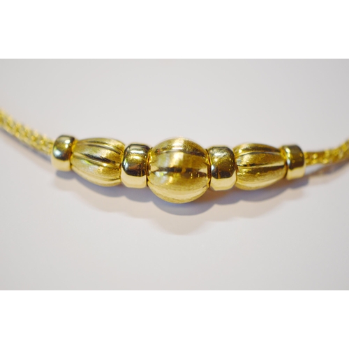 206 - Continental 18ct gold necklace and matching bracelet, with fluted beads, '.750', 22.6g gross.