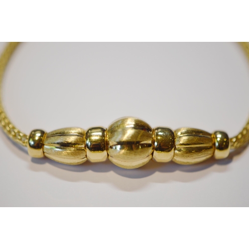 206 - Continental 18ct gold necklace and matching bracelet, with fluted beads, '.750', 22.6g gross.