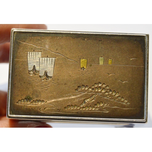 128 - Japanese silver, gold and copper overlaid vesta box holder with lake scene, character marks to under... 