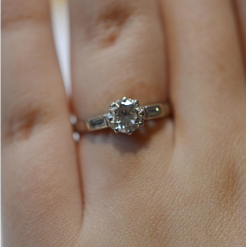 231 - Diamond solitaire ring set with brilliant, approximately .75ct, baguette shoulders, in platinum, siz... 