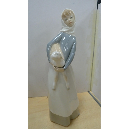 103 - Four Lladro figures to include a female holding a parasol, girl holding a lamb etc.  (4)