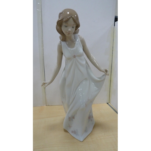 103 - Four Lladro figures to include a female holding a parasol, girl holding a lamb etc.  (4)