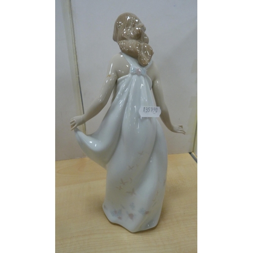 103 - Four Lladro figures to include a female holding a parasol, girl holding a lamb etc.  (4)