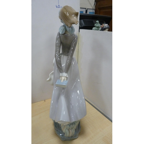 103 - Four Lladro figures to include a female holding a parasol, girl holding a lamb etc.  (4)