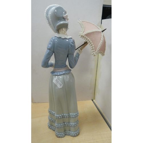 103 - Four Lladro figures to include a female holding a parasol, girl holding a lamb etc.  (4)