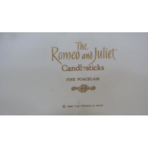 104 - Pair of Franklin Mint fine porcelain candlesticks modelled as Romeo and Juliet on oval bases.  ... 