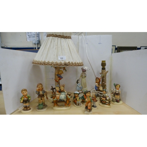 105 - Collection of Goebel Hummel figures, two Hummel table lamps, and a mother and child group.