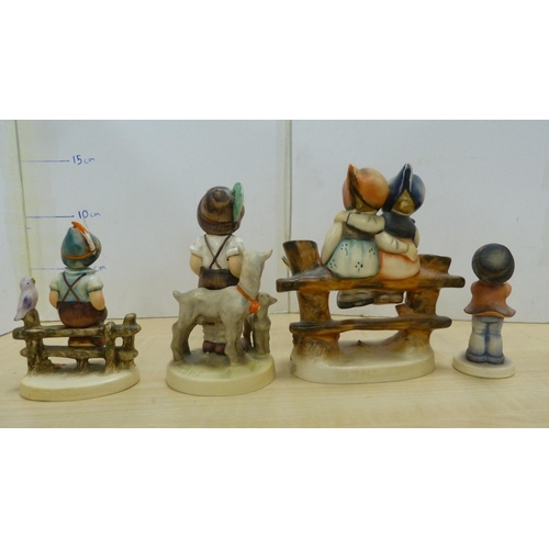 105 - Collection of Goebel Hummel figures, two Hummel table lamps, and a mother and child group.