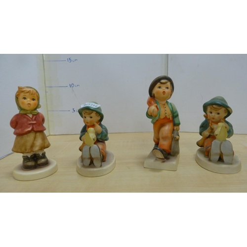 105 - Collection of Goebel Hummel figures, two Hummel table lamps, and a mother and child group.