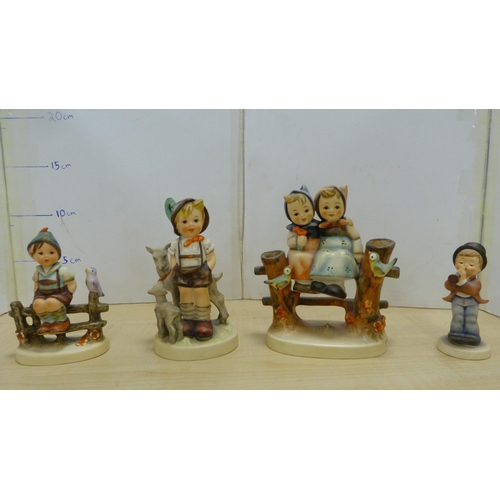 105 - Collection of Goebel Hummel figures, two Hummel table lamps, and a mother and child group.