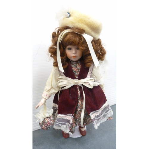 114 - Five porcelain-headed dolls, all with clothing.  (5)