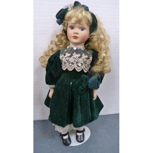 114 - Five porcelain-headed dolls, all with clothing.  (5)