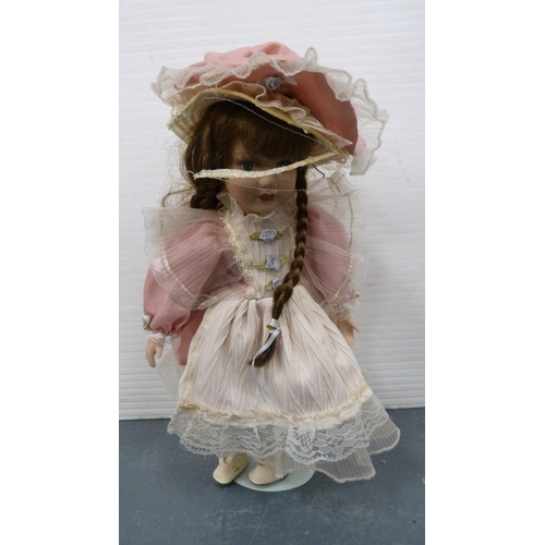 114 - Five porcelain-headed dolls, all with clothing.  (5)