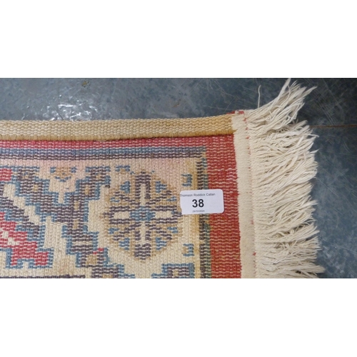 38 - Machine-made Persian design rug adorned with animals and geometric motifs, on red ground.