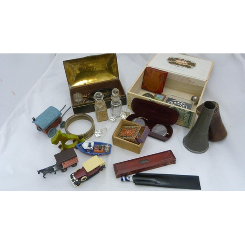410 - Box of curios to include an Indian brass box, bangle, spectacles etc.