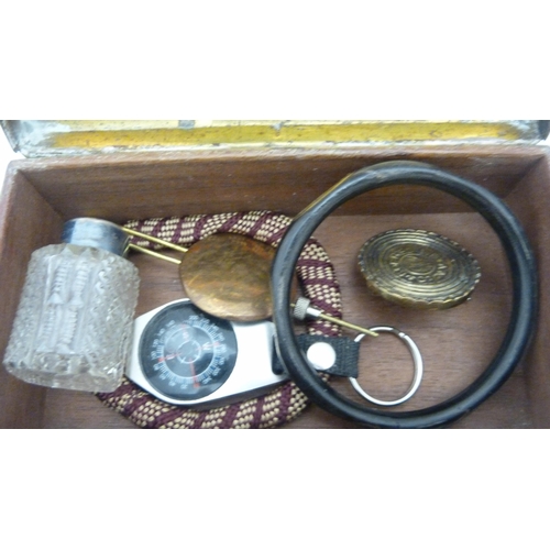 410 - Box of curios to include an Indian brass box, bangle, spectacles etc.
