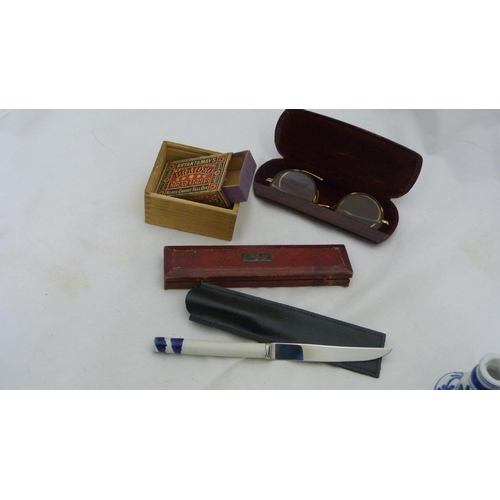 410 - Box of curios to include an Indian brass box, bangle, spectacles etc.